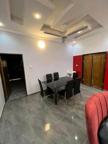 a dining room with a black table and chairs at As résidence meubles E p in Ouagadougou