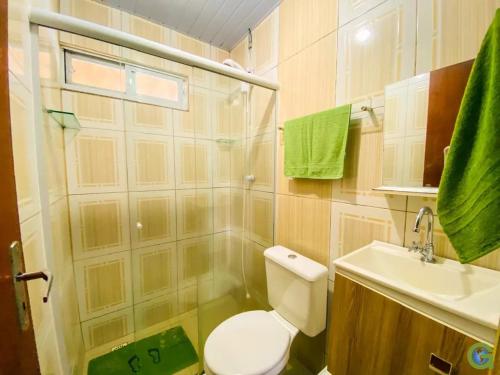 a bathroom with a toilet and a sink and a shower at Pousada Inn Nature in Palhoça