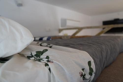 a bed with a blanket on top of it at Flowers Lullaby Loft in Afantou