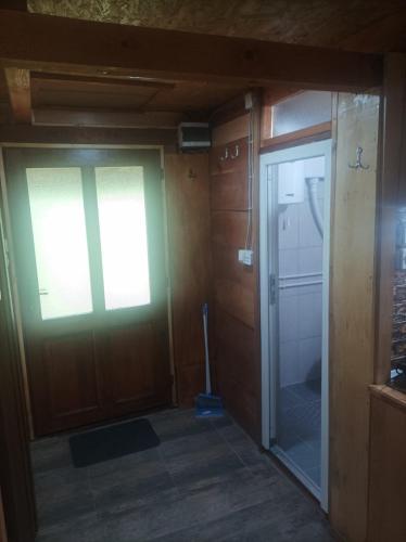 an empty room with a door and a window at Vajat Kraljevica in Rudnik Kačerski