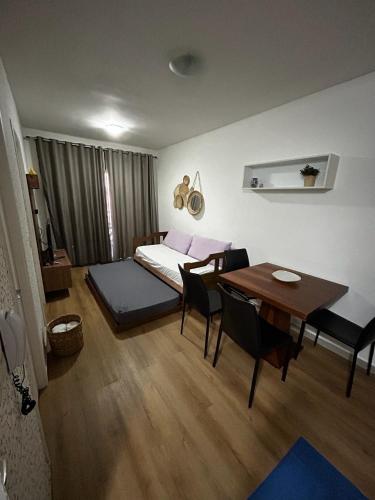 a bedroom with a bed and a table and chairs at VG Fun Beach Front Apartamentos in Fortaleza