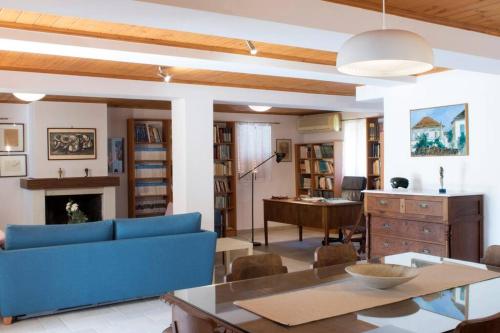 a living room with a blue couch and a table at traditional village house in Ariokhórion