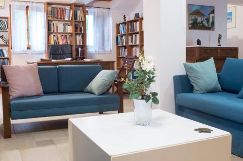 a living room with two blue couches and a table at traditional village house in Ariokhórion
