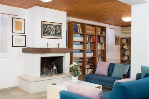 a living room with a couch and a fireplace at traditional village house in Ariokhórion