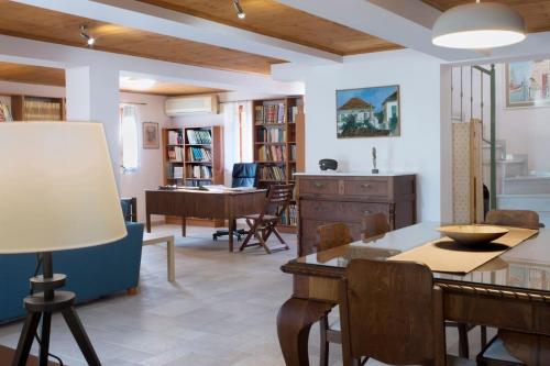 a dining room and living room with a table and chairs at traditional village house in Ariokhórion