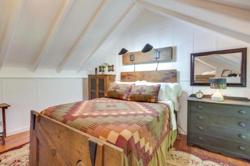 a bedroom with a bed with a dresser and a mirror at Restored Buchanan Log Cabin on 9-Mile Creek! in Reba