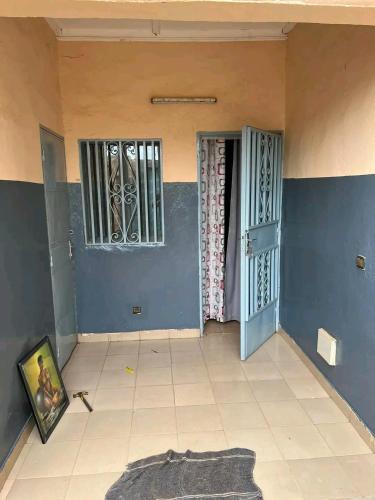 a room with two doors and a rug on the floor at As résidence meubles k in Ouagadougou