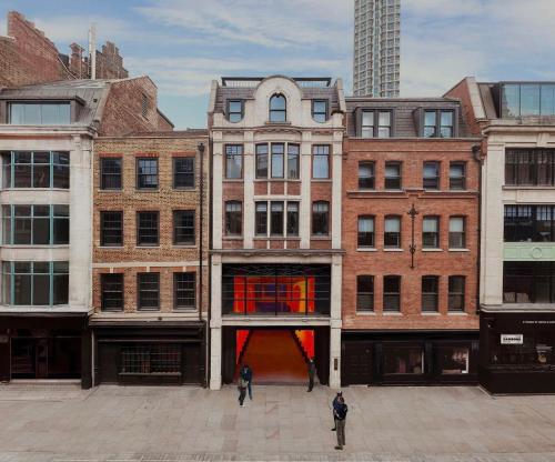 a group of buildings with people standing in a courtyard at Chateau Denmark London in London