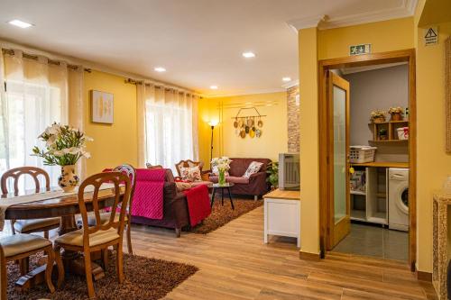 a living room with a couch and a table at CASA DA ROSARINHO - Casa de Férias com Piscina - Arcos de Valdevez in Arcos de Valdevez