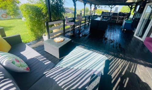 a patio with a couch and a table and chairs at Monte do Bidé Private Farm Peace and Nature in Setúbal