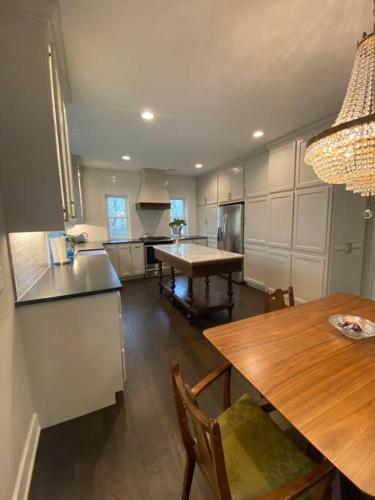 a kitchen with a wooden table and a dining room at Carriage House on Historic Bentonville Square in Bentonville