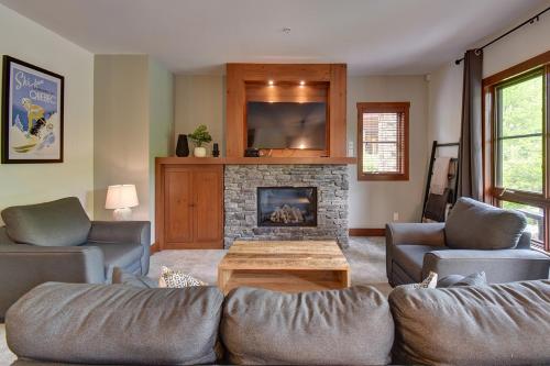 モントランブランにあるTremblant Prestige - Étoile 1510-23の2つのソファと暖炉のあるリビングルーム