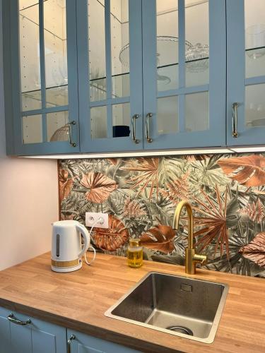 a kitchen counter top with a sink and a counter top at M&M Doki Studio in Gdańsk