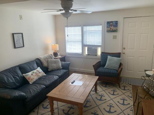 a living room with a couch and a coffee table at Sandy Mutts at the Beach cottage in North Camellia Acres