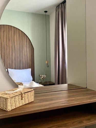 a bedroom with a bed with a mirror on a table at Αura Luxury Apartments in Ierissos