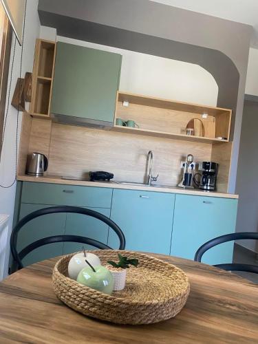 a table with a bowl of fruit on top of it at Αura Luxury Apartments in Ierissos