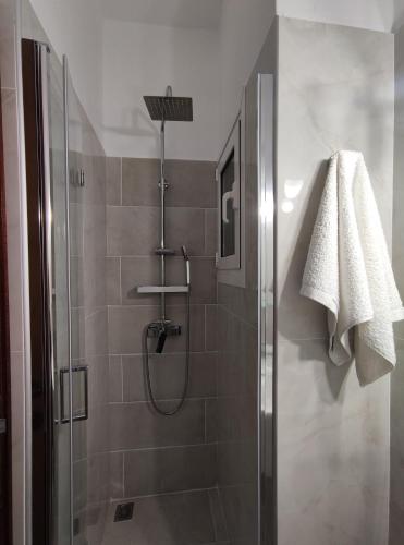 a bathroom with a shower with a glass door at Paradise Garden Paros in Piso Livadi