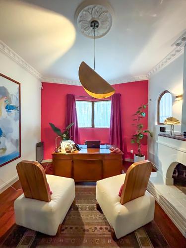 a living room with red walls and a table and chairs at Nokal Exclusive Stay in Mexico City