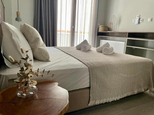 a bedroom with a bed with towels on it at Αura Luxury Apartments in Ierissos