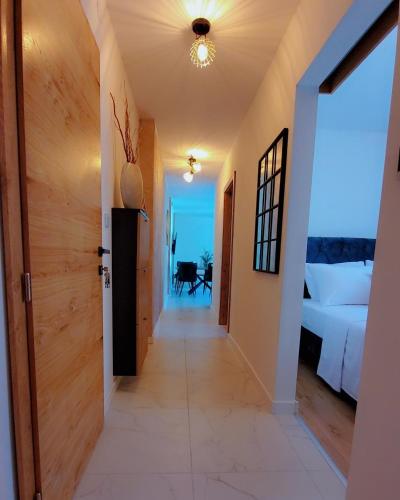 a hallway leading to a bedroom with a bed at Noor Lux Apartments in Bad Hall