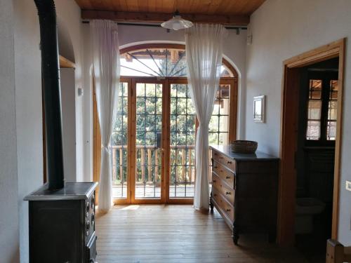 a room with a large window and a dresser and a door at Ca' Becca-Bioglio in Bioglio