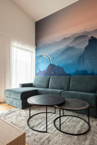 a living room with a couch and a table at Luxury Penthouse - Between Kronplatz, 3 Peaks Dolomites and Lake Prags in Monguelfo