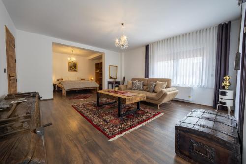 a living room with a couch and a table at Doa Boutique Hotel in Peje