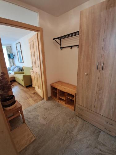 a room with a door and a living room with a couch at Appartement mit Hallenbad in Sankt Martin bei Lofer