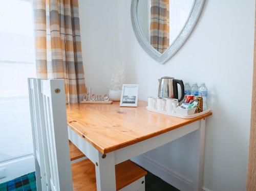 a table with a coffee maker on top of it at Nairn View Guest House in Nairn