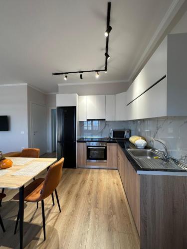 a kitchen with a table and a dining room at classy apartment Lea 3 in Durrës
