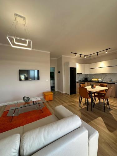 a living room with a white couch and a table at classy apartment Lea 3 in Durrës