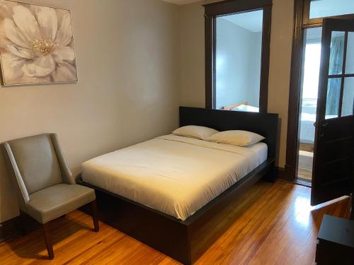 a bedroom with a bed and a chair and a window at 3 BR TH fee Parking Walk 2 Metro in Washington