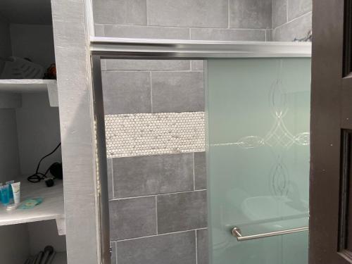 a shower with a glass door in a bathroom at 3 BR TH fee Parking Walk 2 Metro in Washington