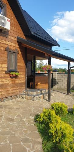 a house with a patio with a roof at Садиба For Rest in Svityazʼ
