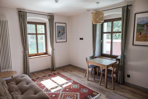 a living room with a couch and a table at Willa Bywaj Zdrój in Lądek-Zdrój