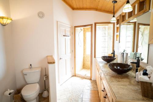 a bathroom with two sinks and a toilet at Homer Inn & Spa in Homer