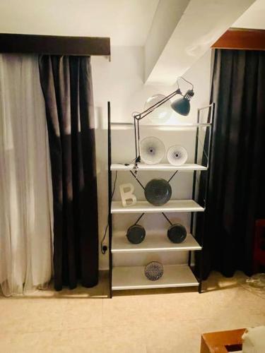 a room with a white shelving unit next to a window at Green Garden Guest House in Mağusa