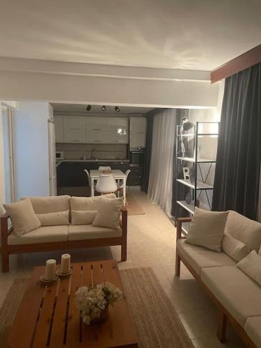a living room with two couches and a table at Green Garden Guest House in Mağusa