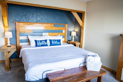 a bedroom with a large bed with a wooden headboard at Homer Inn & Spa in Homer