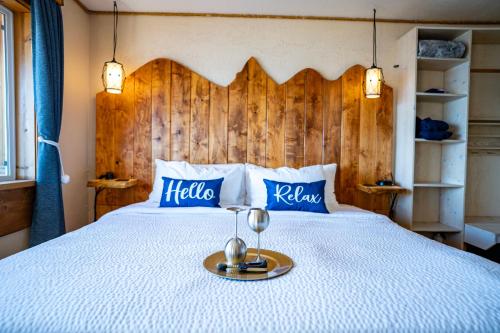 a bedroom with a large bed with a wooden headboard at Homer Inn & Spa in Homer
