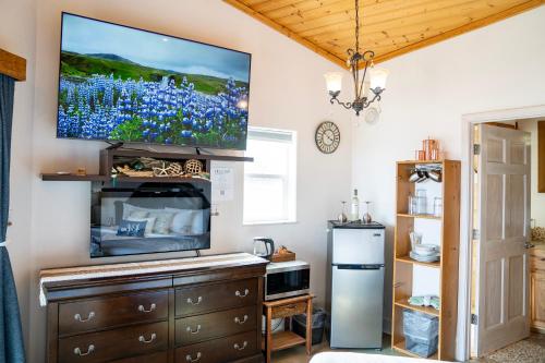 a living room with a flat screen tv on the wall at Homer Inn & Spa in Homer