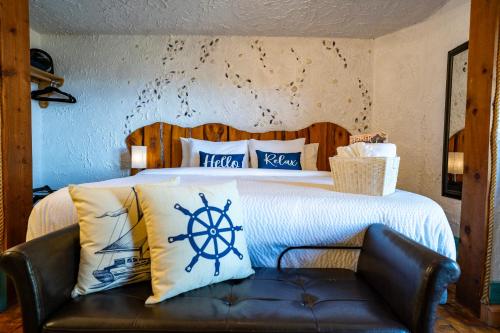 a bedroom with a bed with a nautical pillows at Homer Inn & Spa in Homer