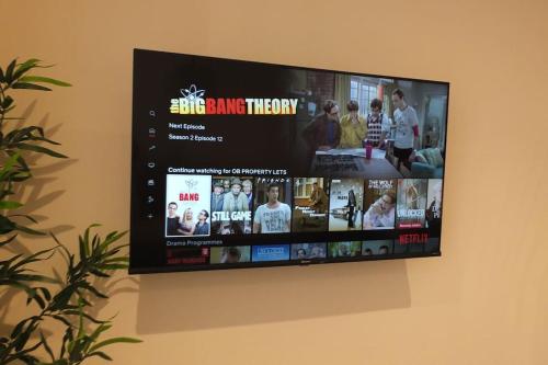 a flat screen tv hanging on a wall at Entire Prestige Apartment in Poole Quay - Free Parking, Fast WiFi, Smart TV & Netflix in Poole