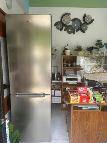 a stainless steel refrigerator in a kitchen at Hospedaria Firmino Bernardino in Odeceixe