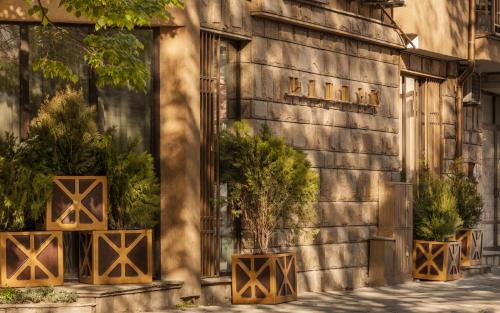 a building with potted plants on the side of it at HIDDEN BANK: DIAMONDS in Plovdiv