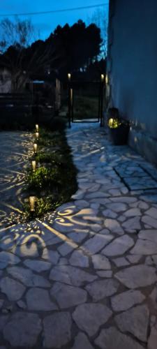 a stone walkway with lights on the side of a building at Domaine de La Sarrotte in Saugon