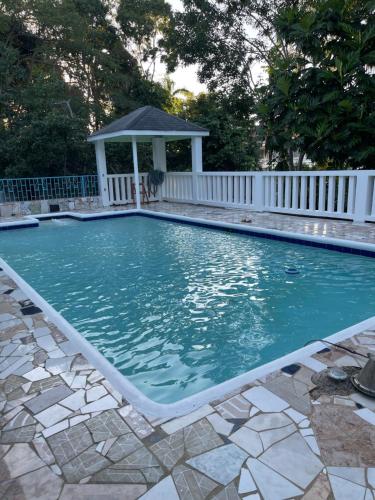 a swimming pool with a gazebo at Peaceful Private Home With Exclusive Swimming Pool in Montego Bay