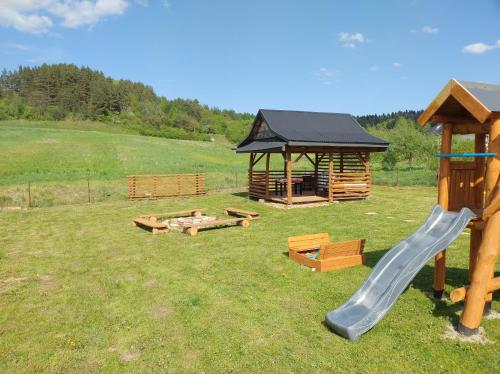 a playground with a slide and a gazebo at Domek u Gołąbków Bieszczady in Lesko