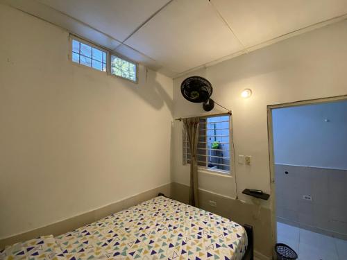 a small bedroom with a bed and a window at Casa Mi Valle Loft in Santa Marta