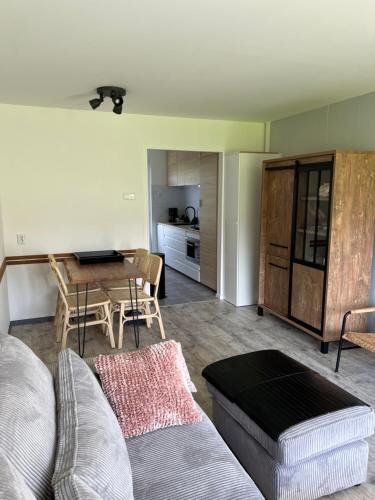 a living room with a couch and a table at Vakantiehuisje Martina 11 in Vlissingen